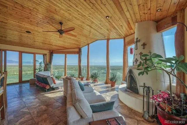 a living room with furniture ceiling fan and a rug