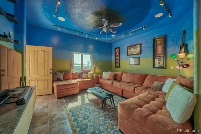 a living room with furniture and a chandelier