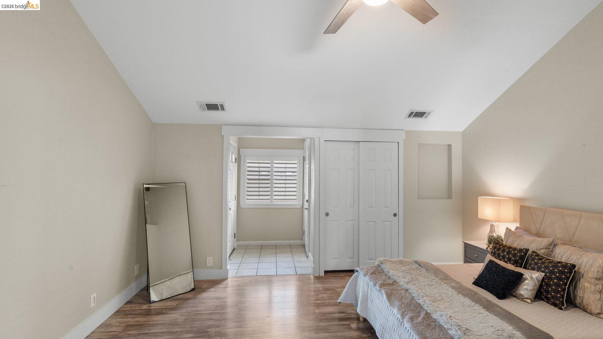 700 Brownstone Road Oakley, CA 94561 - Photo 26 of 58 Spacious room featuring wood-finish flooring, light neutral wall paint, and a vaulted ceiling with a ceiling fan
