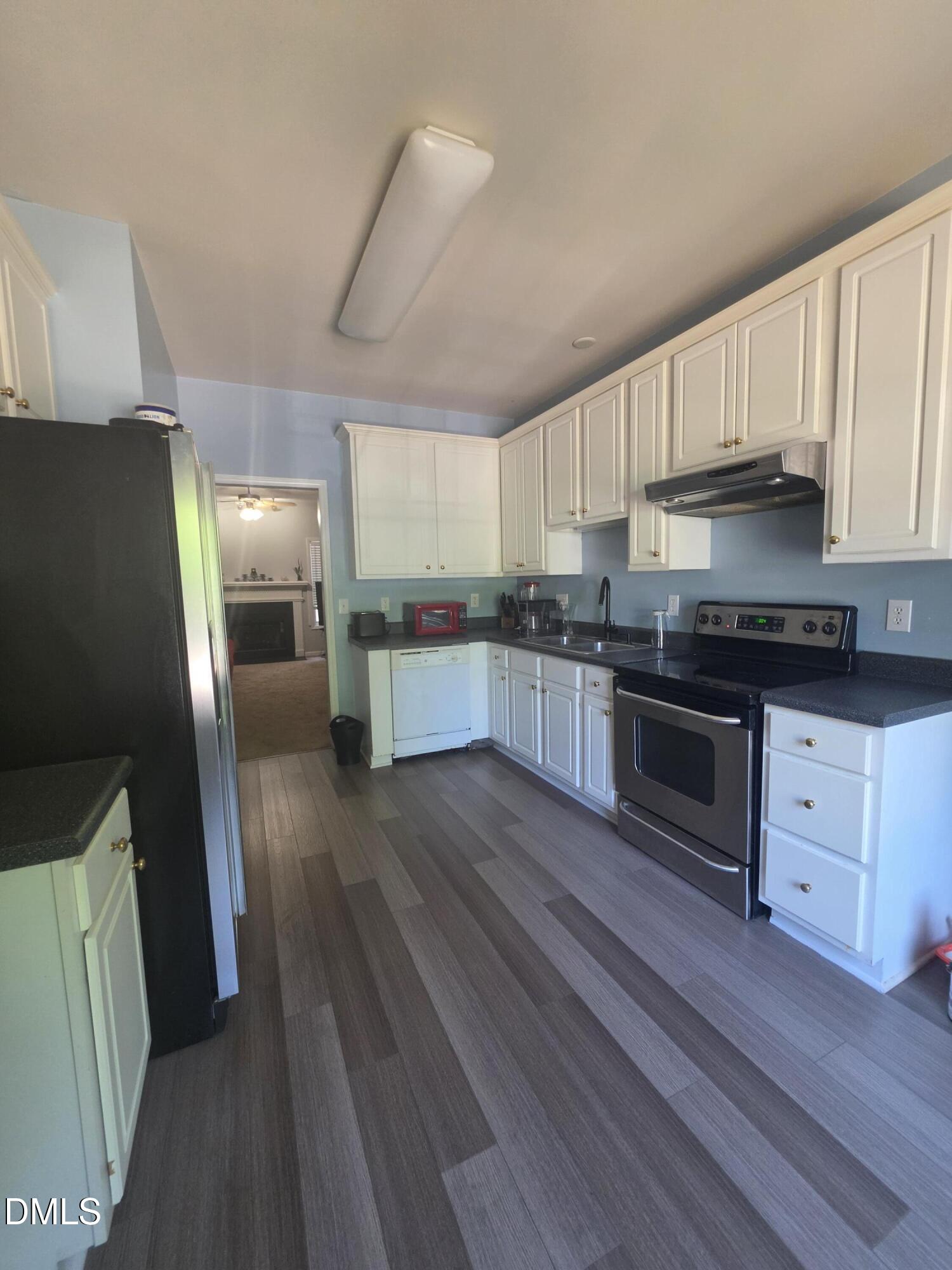 2405 Trout Stream Drive Raleigh, NC 27604 - Photo 2 of 13 a kitchen with granite countertop a refrigerator stove top oven and sink