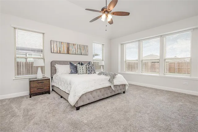 a bedroom with a large bed and a large window