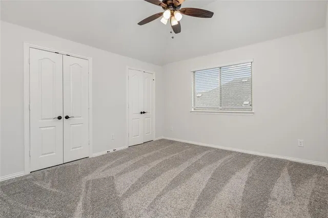 a view of a livingroom with a ceiling fan and window