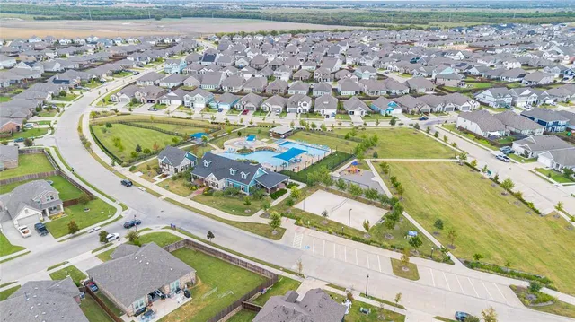 view of a swimming pool with a yard