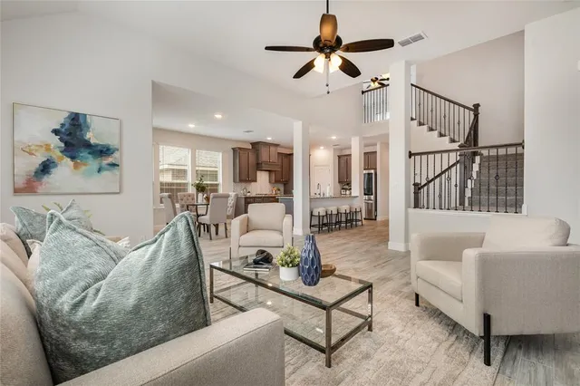 a living room with furniture and kitchen view