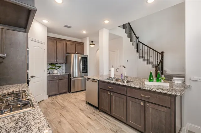 a kitchen with a sink appliances and cabinets