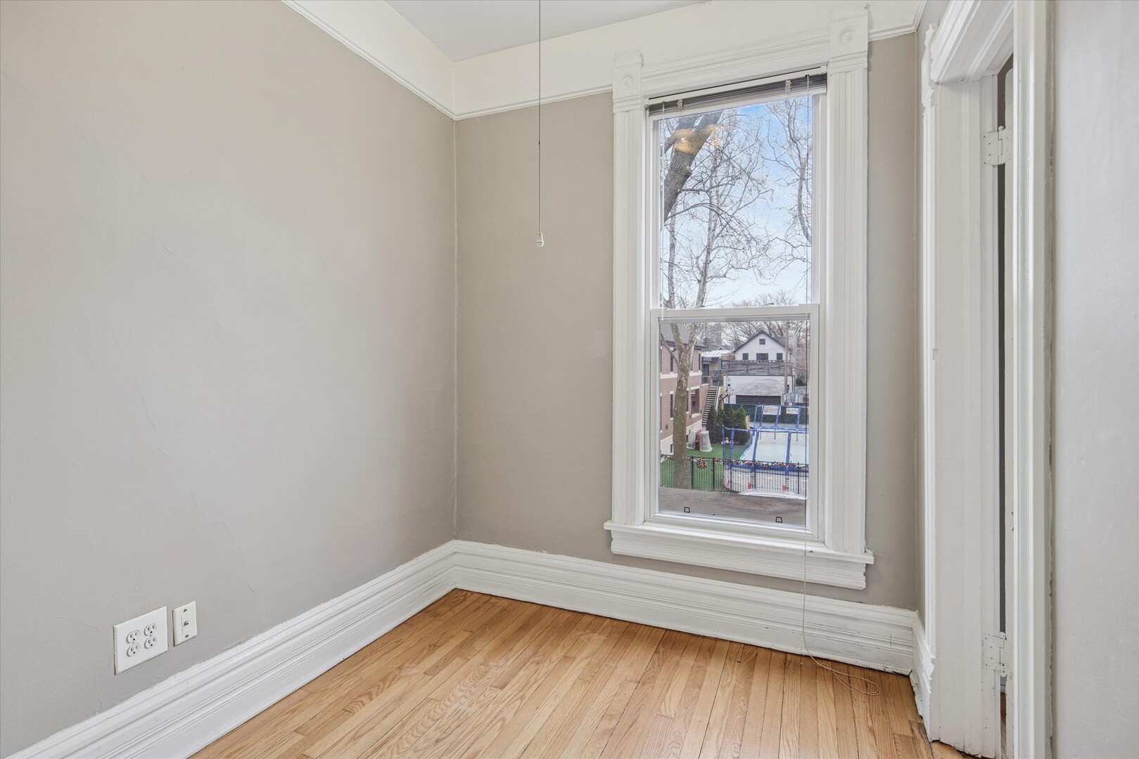 3818 North Hermitage Avenue, Unit 2 Chicago, IL 60613 - Photo 11 of 16 a view of a small space with wooden floor and a window