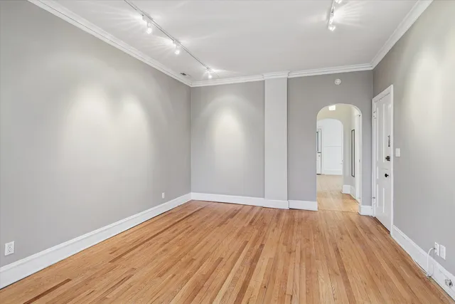 a view of a room with wooden floor and shower