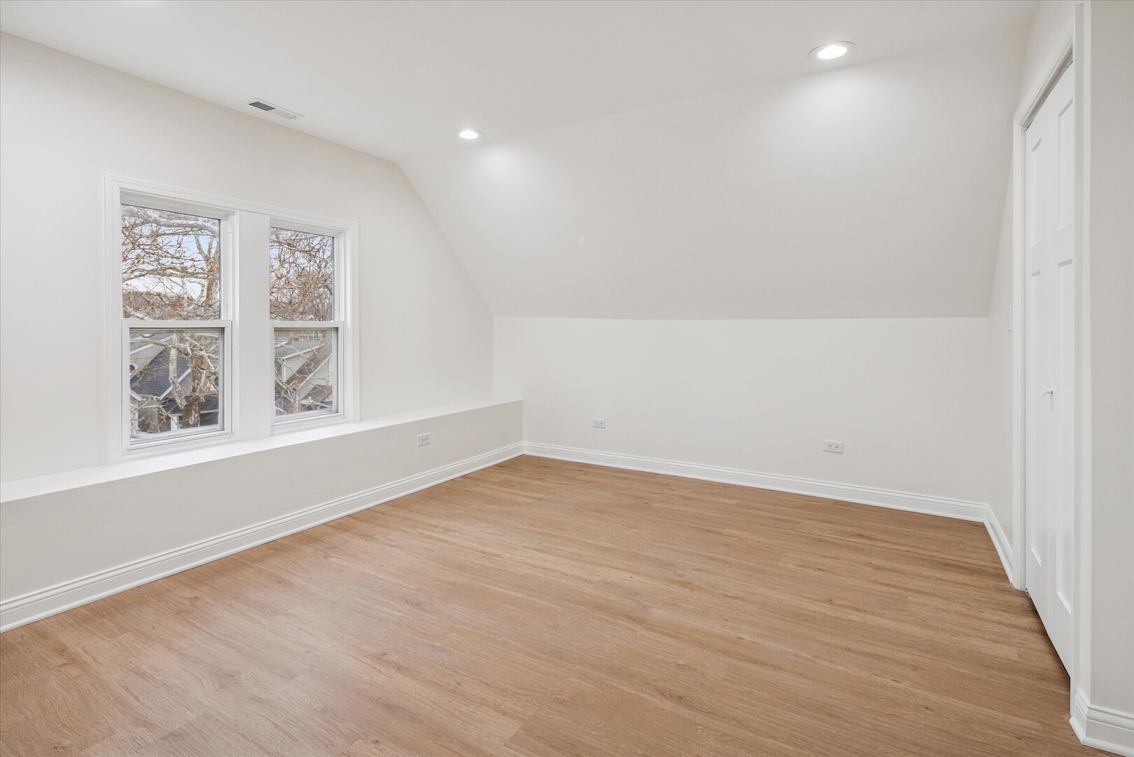 3818 North Hermitage Avenue, Unit 2 Chicago, IL 60613 - Photo 8 of 16 wooden floor in an empty room with a window