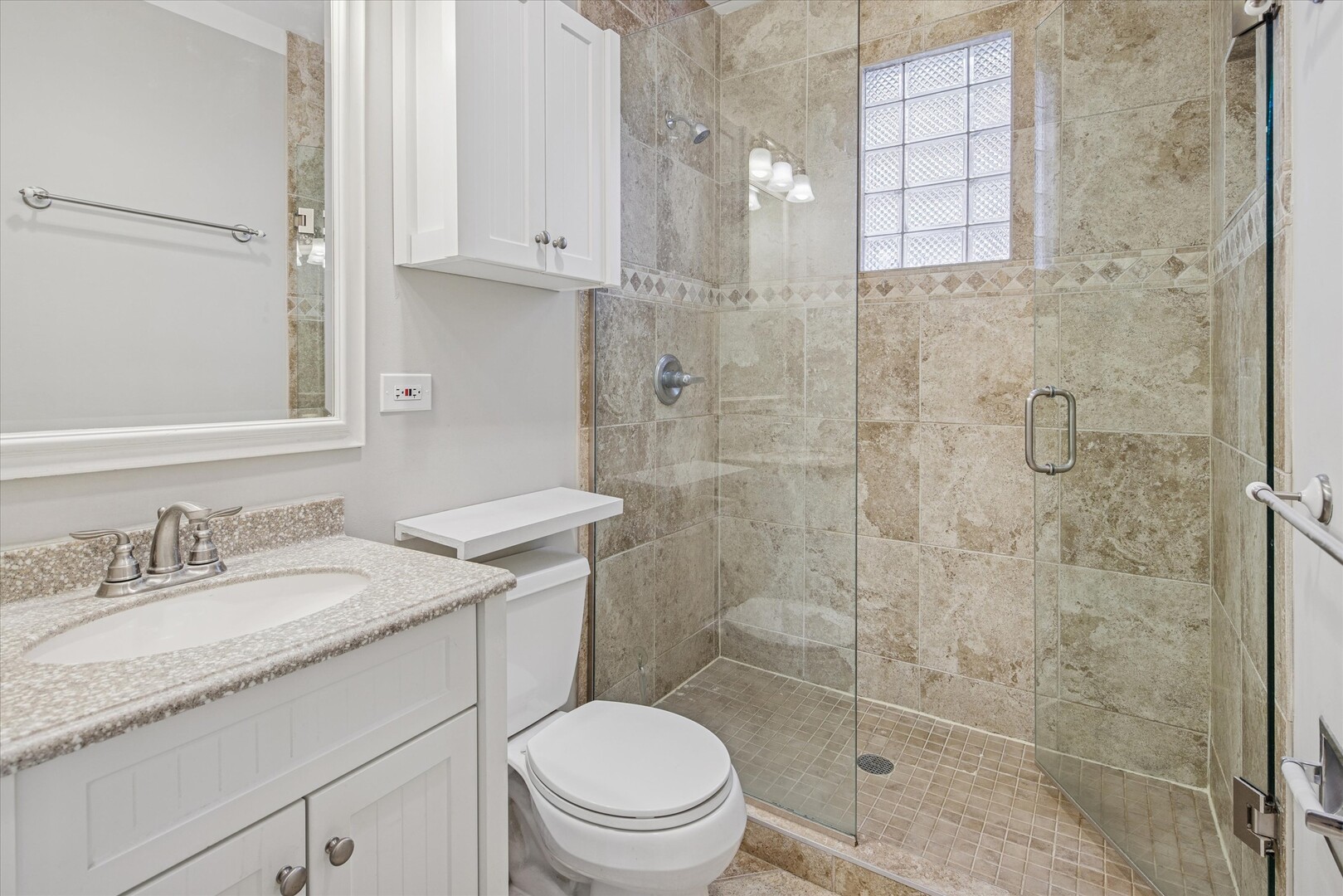 3818 North Hermitage Avenue, Unit 2 Chicago, IL 60613 - Photo 10 of 16 a bathroom with a granite countertop sink a toilet and shower