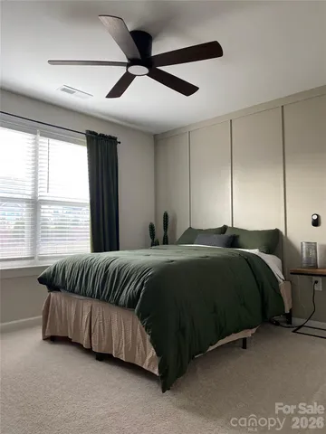 a bedroom with a bed and a couch