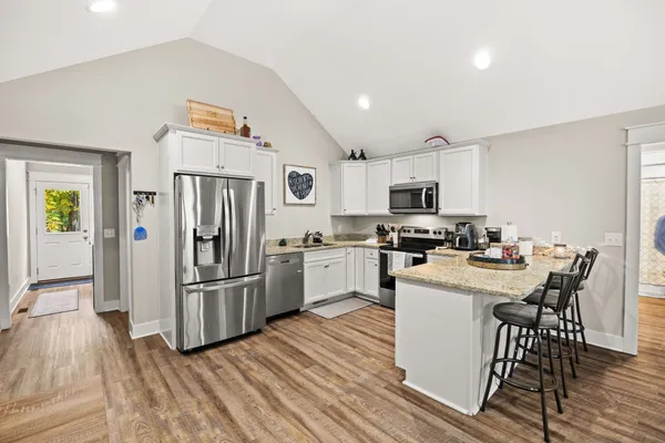 a kitchen with white cabinets and stainless steel appliances