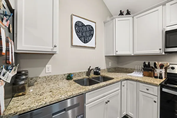 a kitchen with sink cabinets and stove top oven