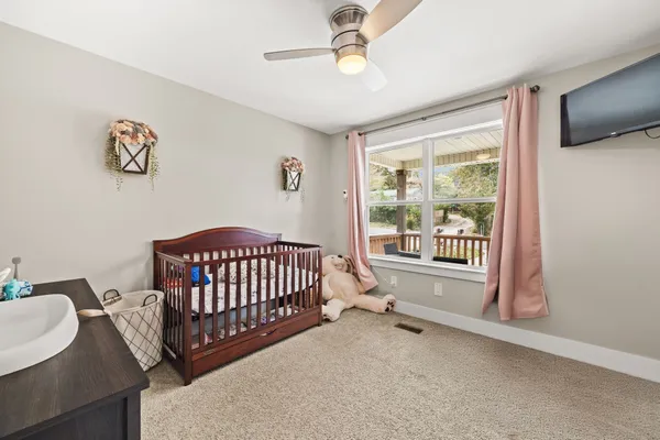 a bedroom with furniture and a window