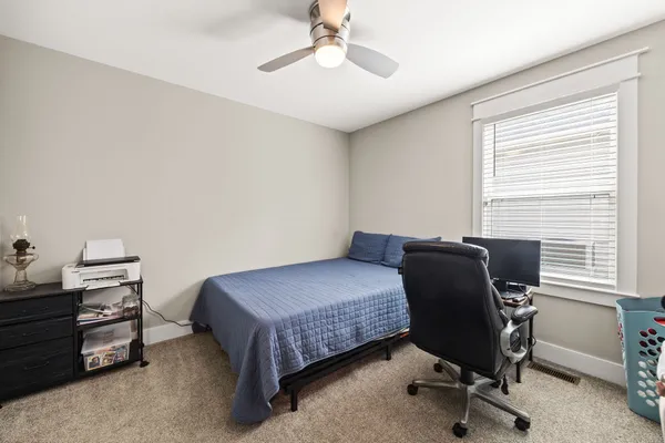 a bedroom with a workspace