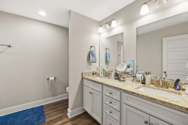 a bathroom with a double vanity sink and a mirror