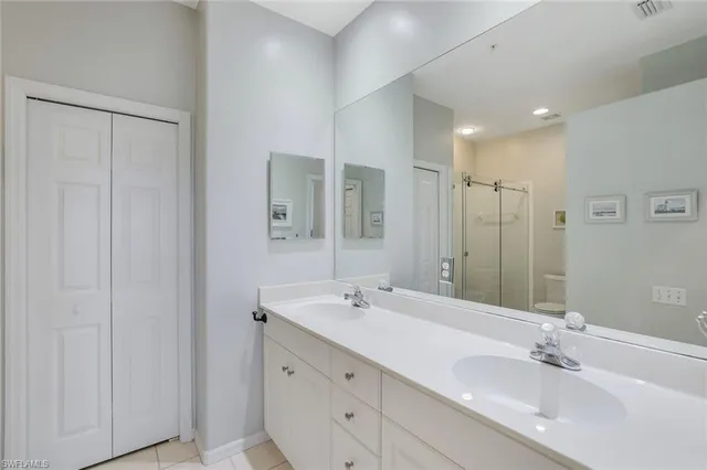 a bathroom with double vanity sink and a mirror