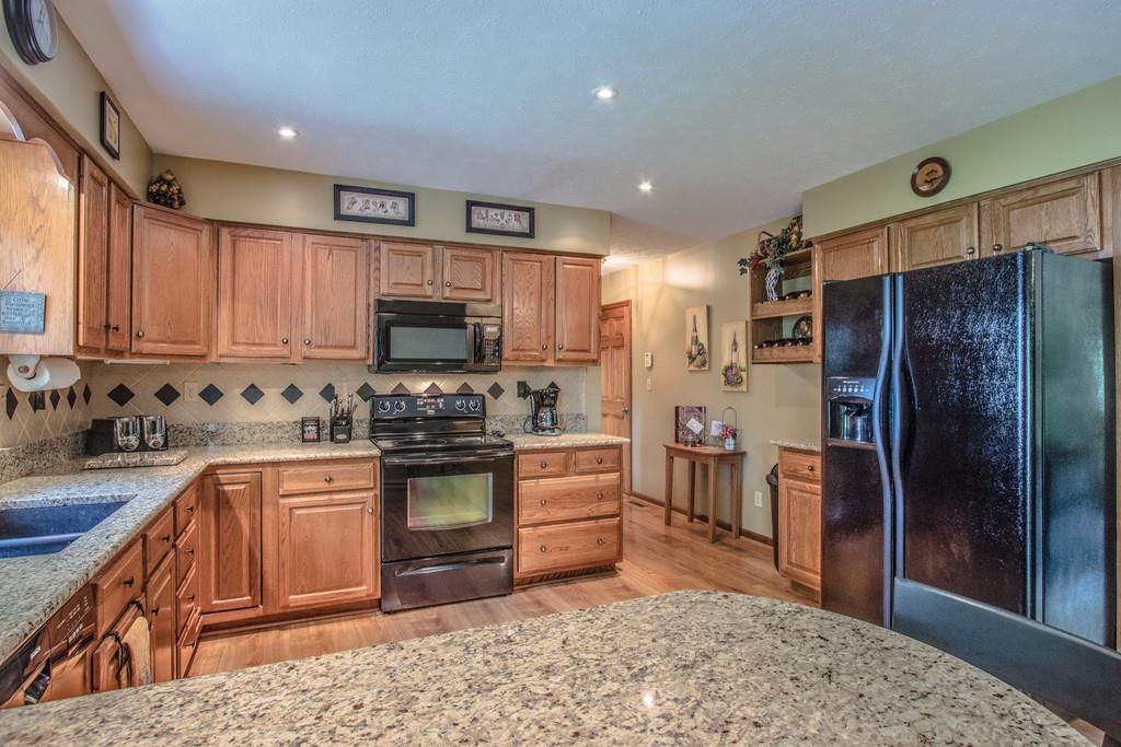 1397 Back Bone Road Sparta, TN 38583 - Photo 13 of 30 a kitchen with stainless steel appliances granite countertop a refrigerator stove and sink
