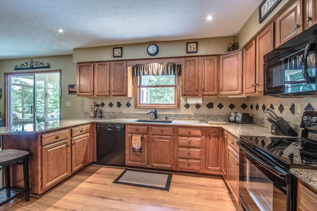 1397 Back Bone Road Sparta, TN 38583 - Photo 15 of 30 a kitchen with stainless steel appliances wooden cabinets and a stove top oven