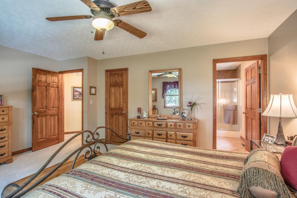 1397 Back Bone Road Sparta, TN 38583 - Photo 19 of 30 a bedroom with a bed and a chandelier