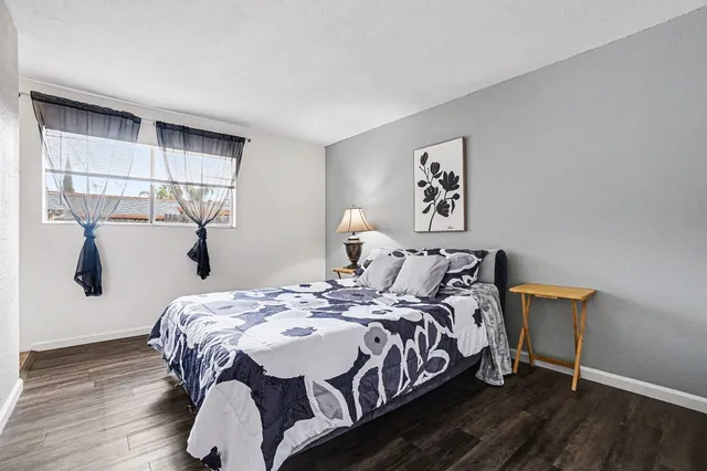 a bedroom with a bed and wooden floor