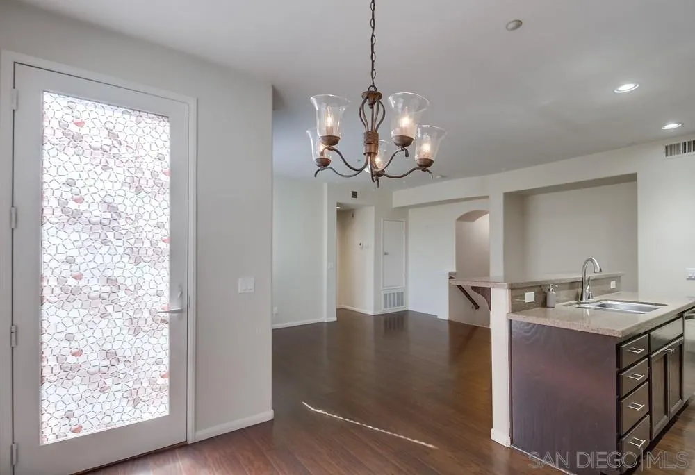 1298 Fools Gold Way, Unit 4 Chula Vista, CA 91913 - Photo 17 of 38 a view of a center island and chandelier