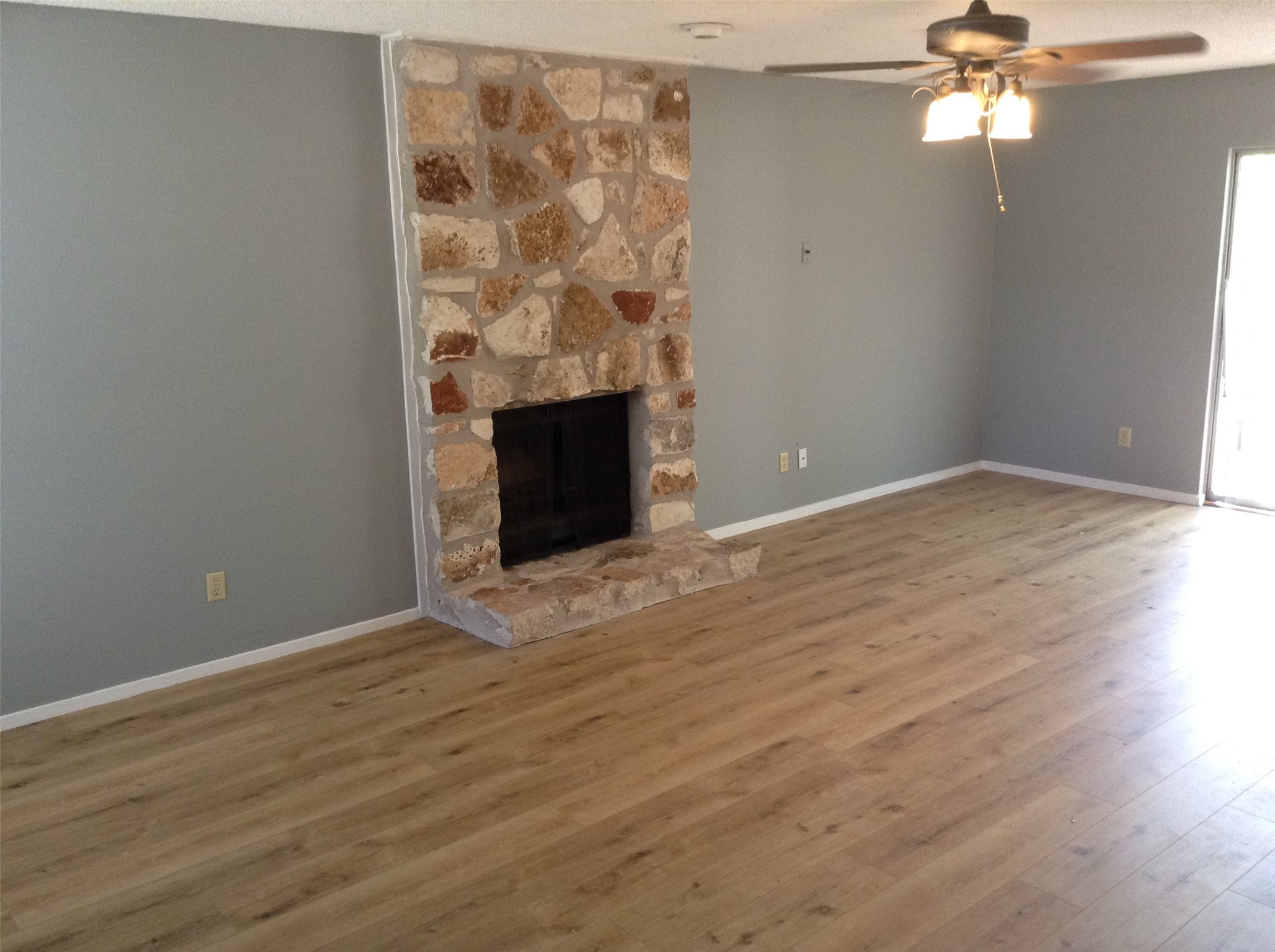 12007 Scribe Drive Austin, TX 78759 - Photo 3 of 35 wooden floor in an empty room with a fireplace