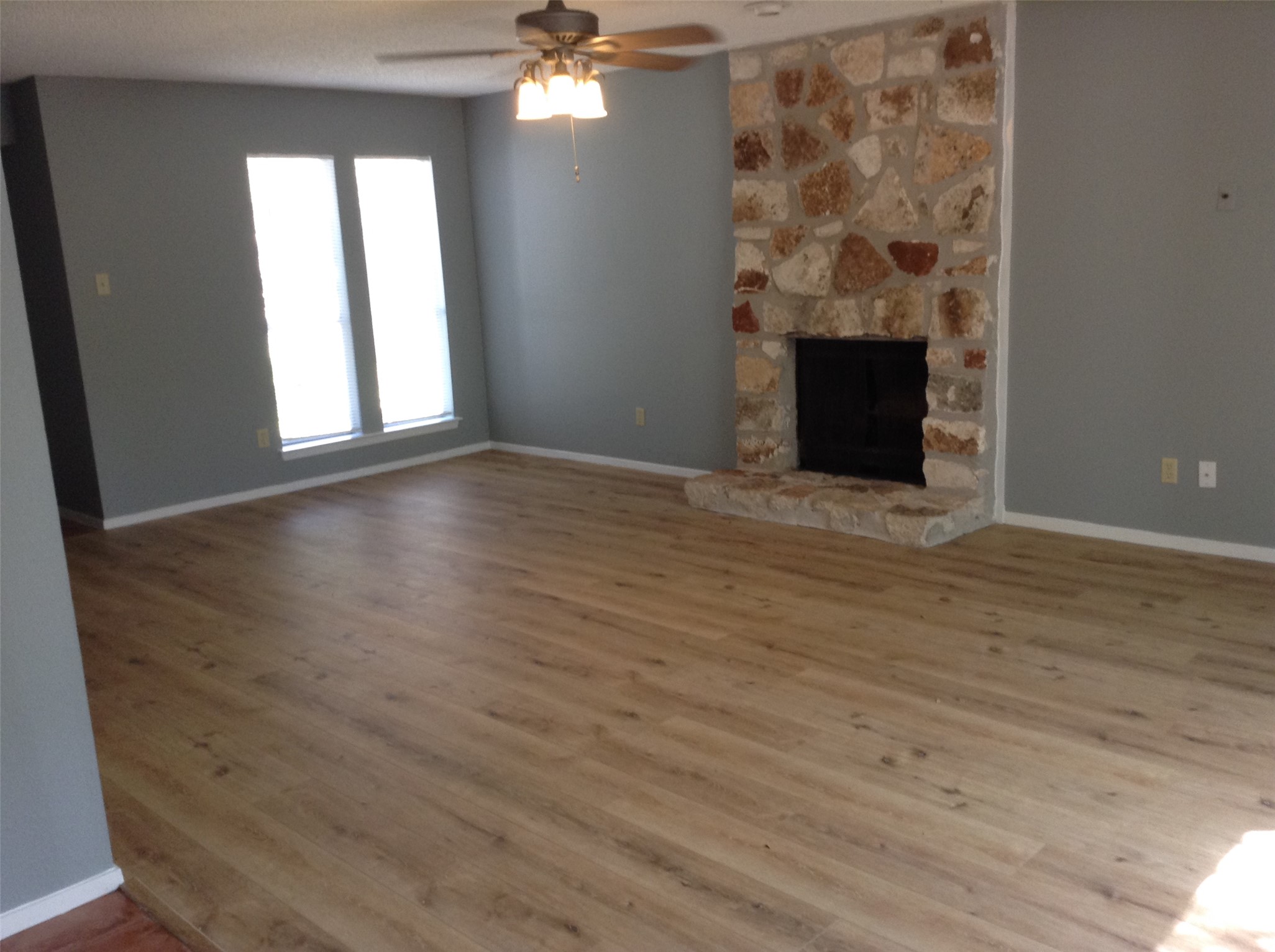 12007 Scribe Drive Austin, TX 78759 - Photo 4 of 35 a view of an empty room with wooden floor and a window
