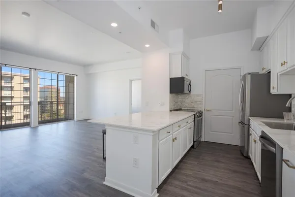 a kitchen with a sink stove and refrigerator