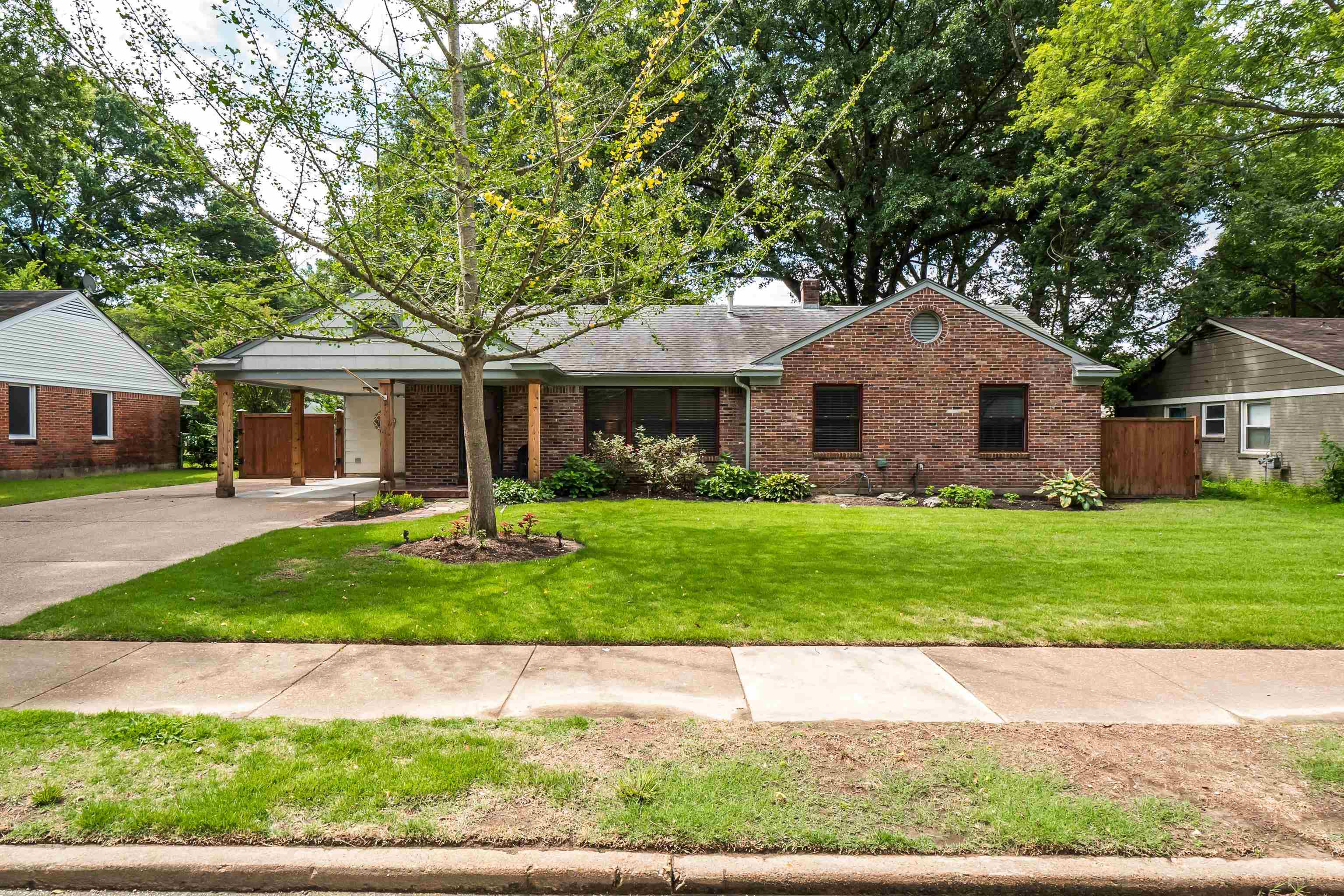 5111 Sequoia Road Memphis, TN 38117 - Photo 1 of 25 a front view of a house with a yard