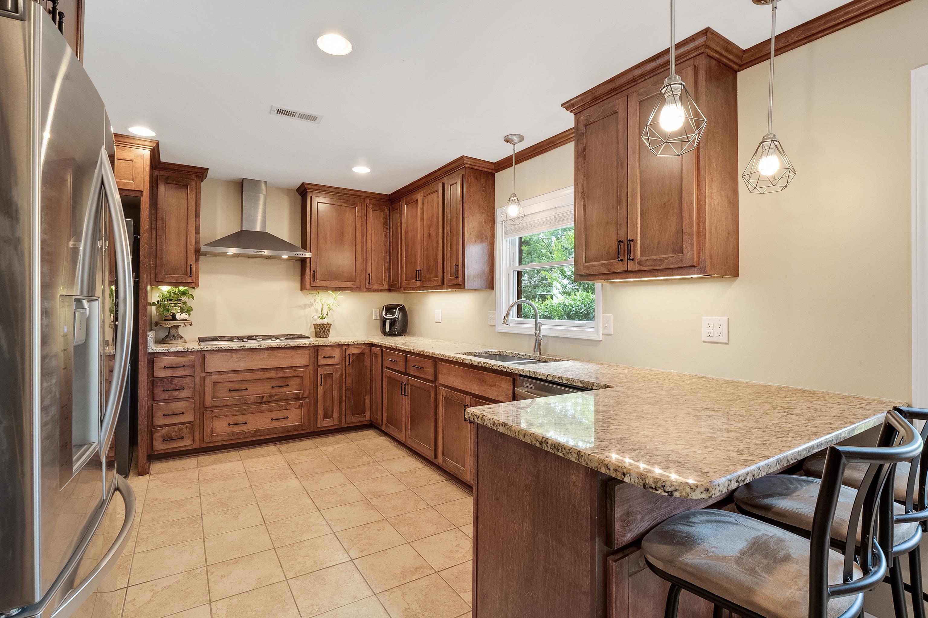 5111 Sequoia Road Memphis, TN 38117 - Photo 8 of 25 a kitchen with a stove a sink and a refrigerator