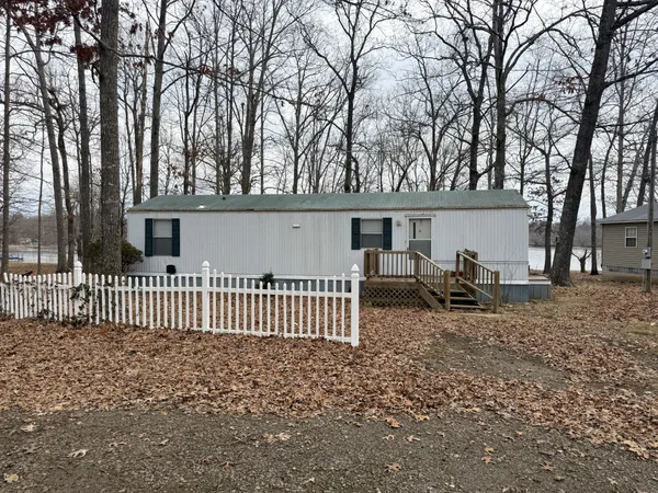 a view of a house with a yard and wooden fence