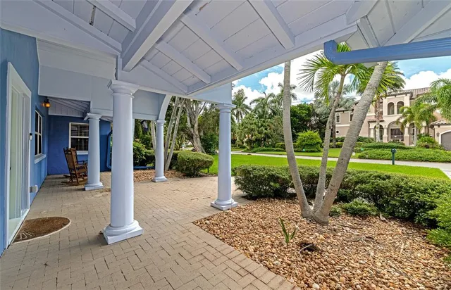 a view of a porch with furniture and garden