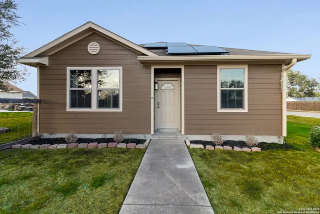 a front view of a house with a yard