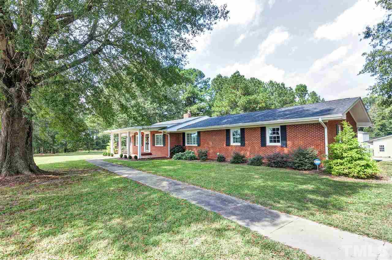 90 Johnson Town Road Zebulon, NC 27597 - Photo 2 of 18 a front view of a house with a garden