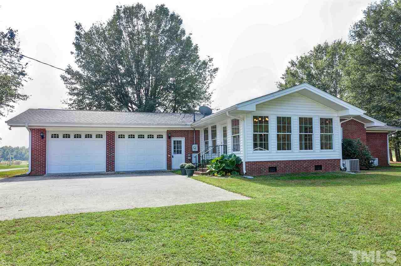 90 Johnson Town Road Zebulon, NC 27597 - Photo 16 of 18 a front view of a house with a yard and garage