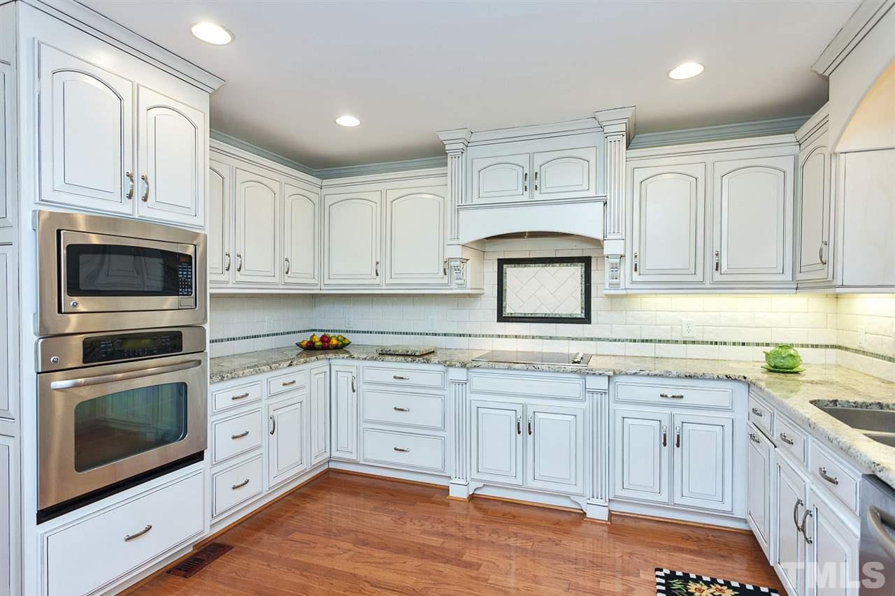 90 Johnson Town Road Zebulon, NC 27597 - Photo 3 of 18 a kitchen with granite countertop white cabinets stainless steel appliances and a sink