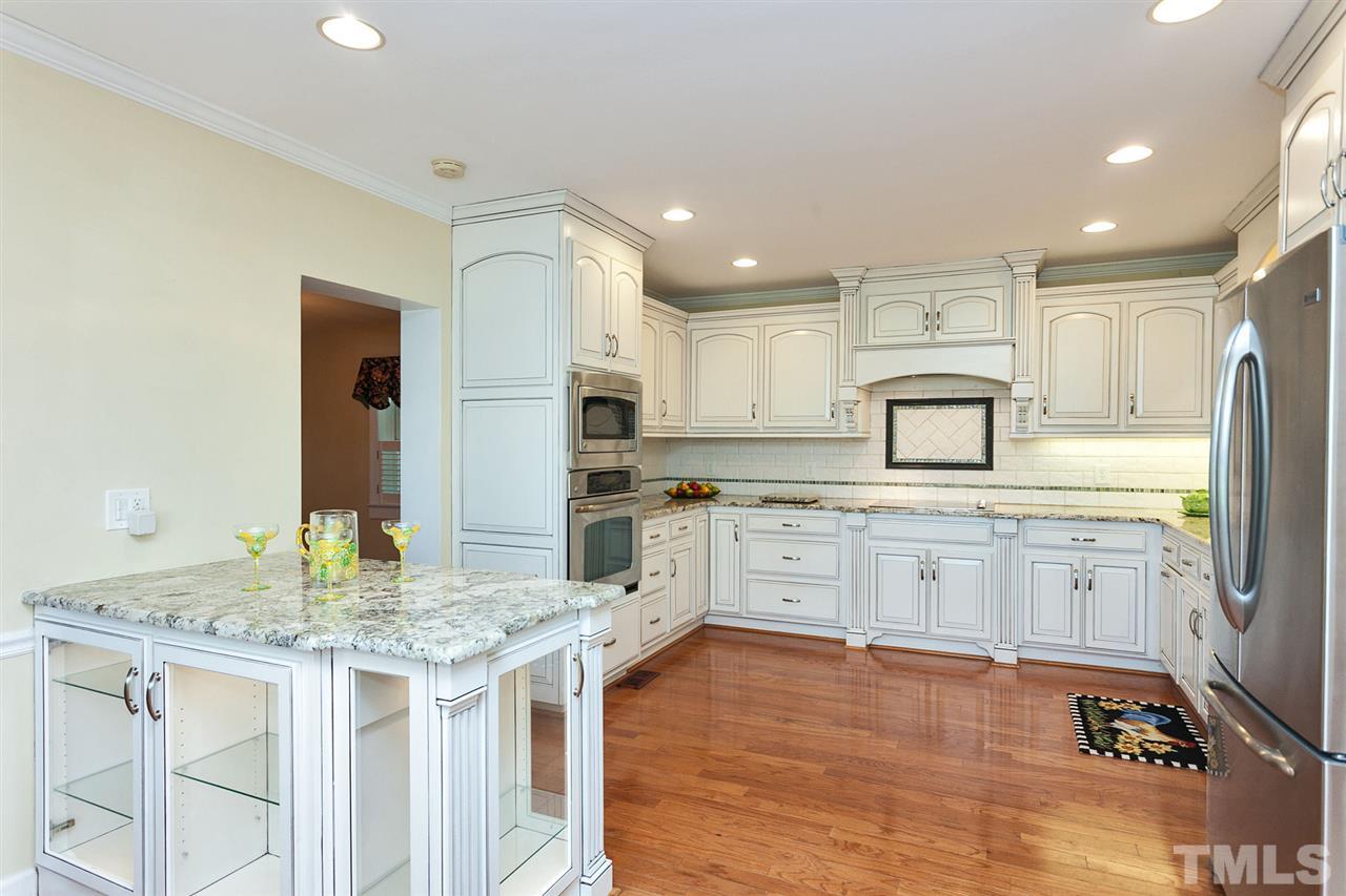 90 Johnson Town Road Zebulon, NC 27597 - Photo 4 of 18 a kitchen with granite countertop white cabinets and refrigerator