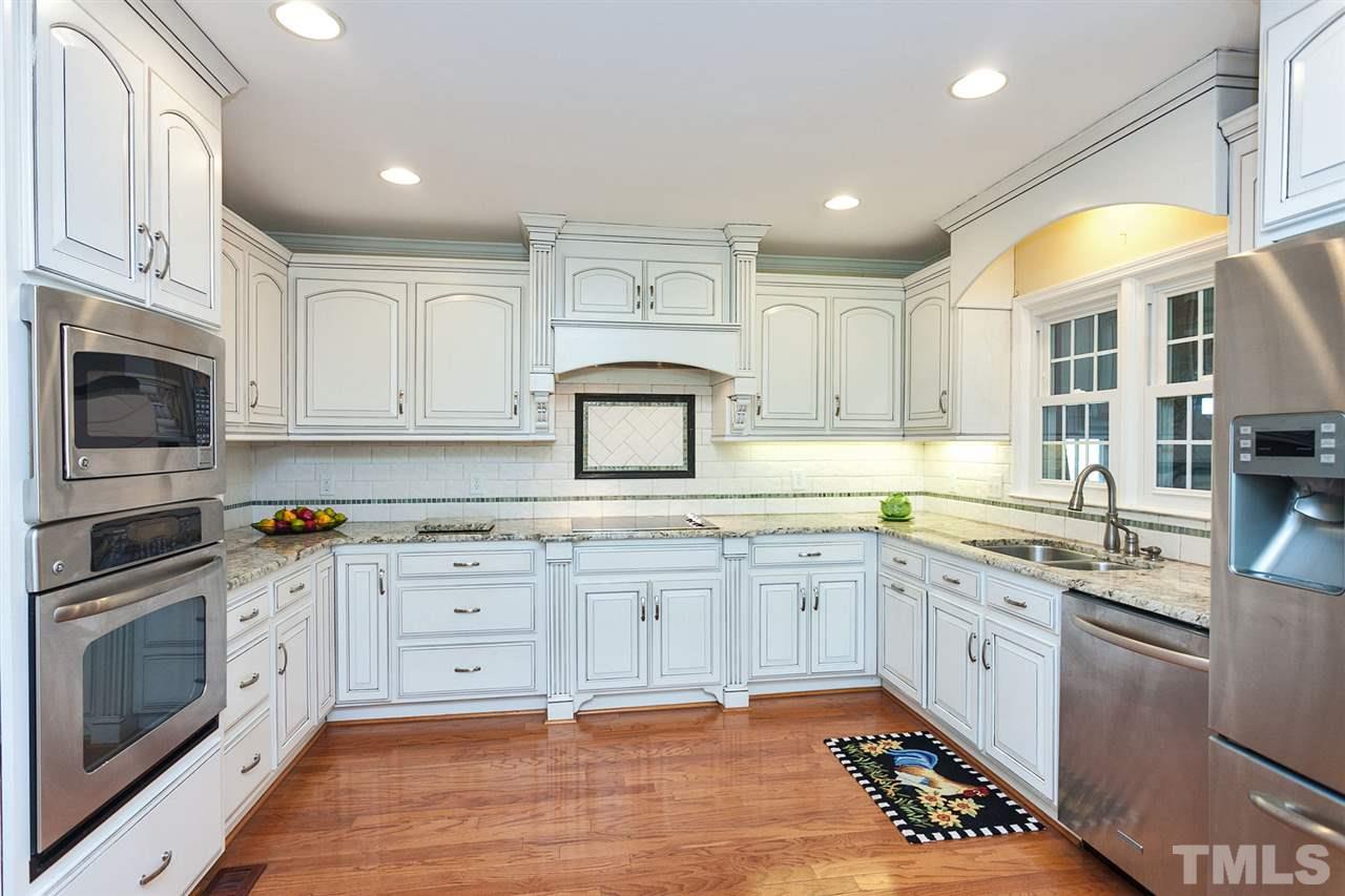 90 Johnson Town Road Zebulon, NC 27597 - Photo 5 of 18 a kitchen with granite countertop a sink stainless steel appliances and cabinets