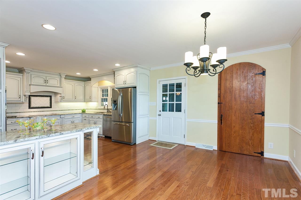 90 Johnson Town Road Zebulon, NC 27597 - Photo 7 of 18 a kitchen with stainless steel appliances kitchen island granite countertop a refrigerator a stove and a wooden floors