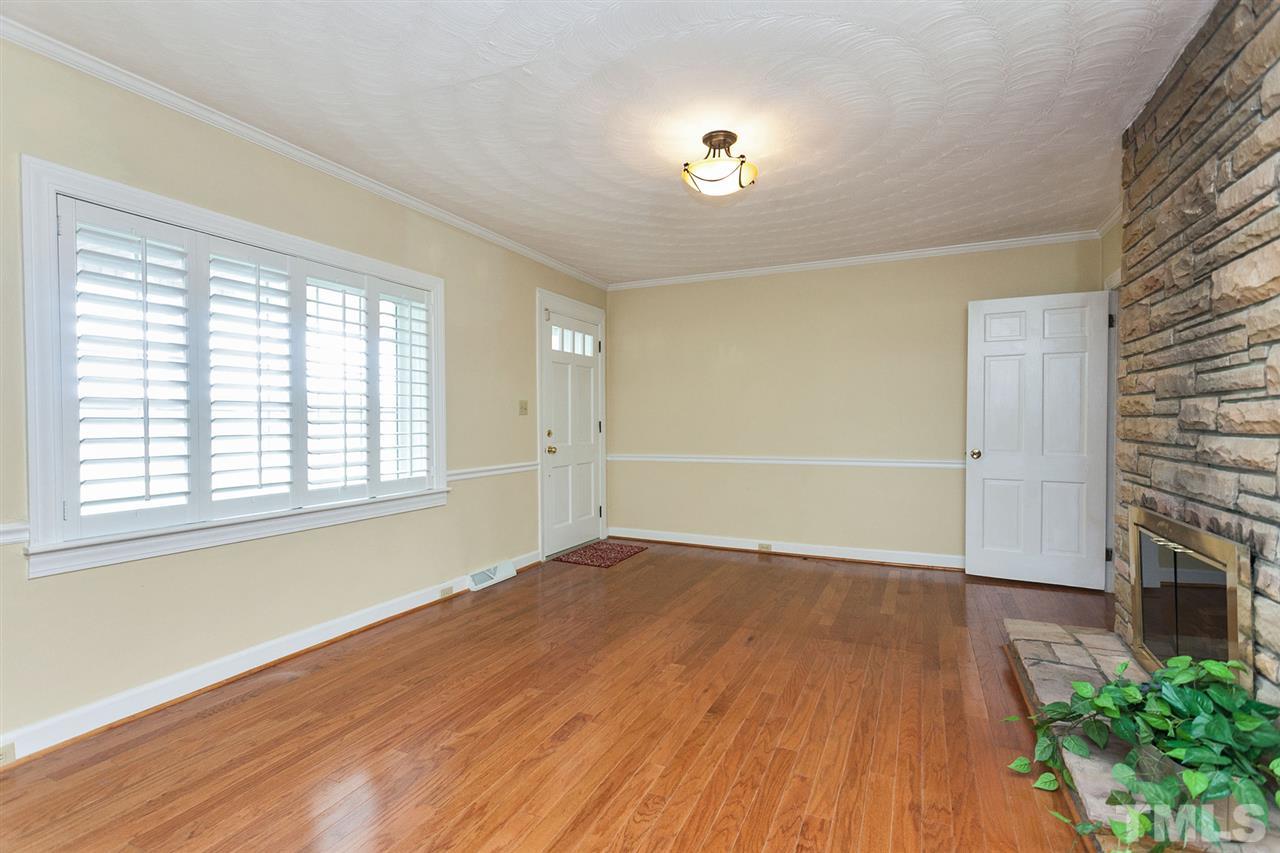 90 Johnson Town Road Zebulon, NC 27597 - Photo 8 of 18 an empty room with wooden floor and windows