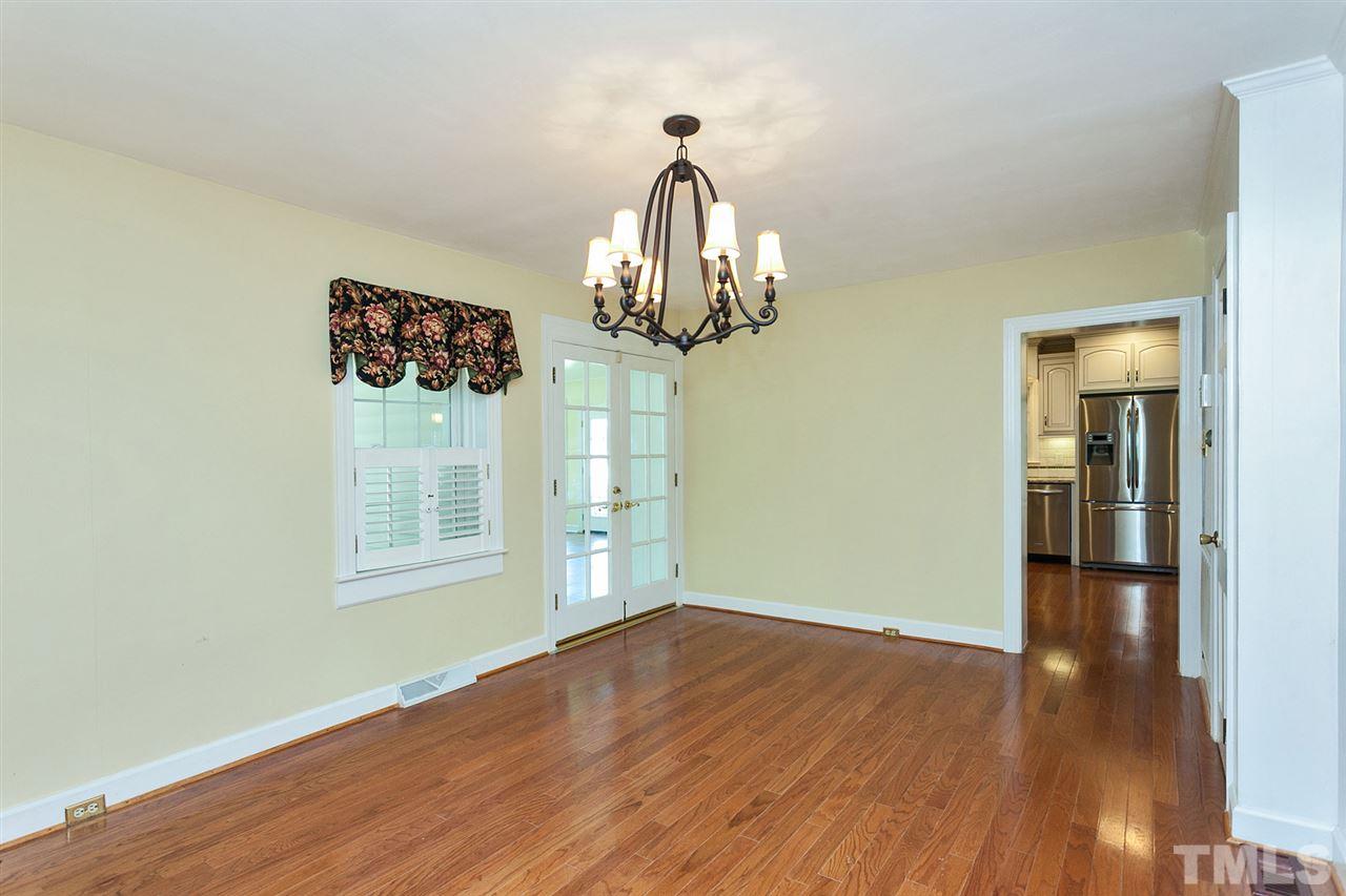 90 Johnson Town Road Zebulon, NC 27597 - Photo 9 of 18 an empty room with wooden floor chandelier and windows