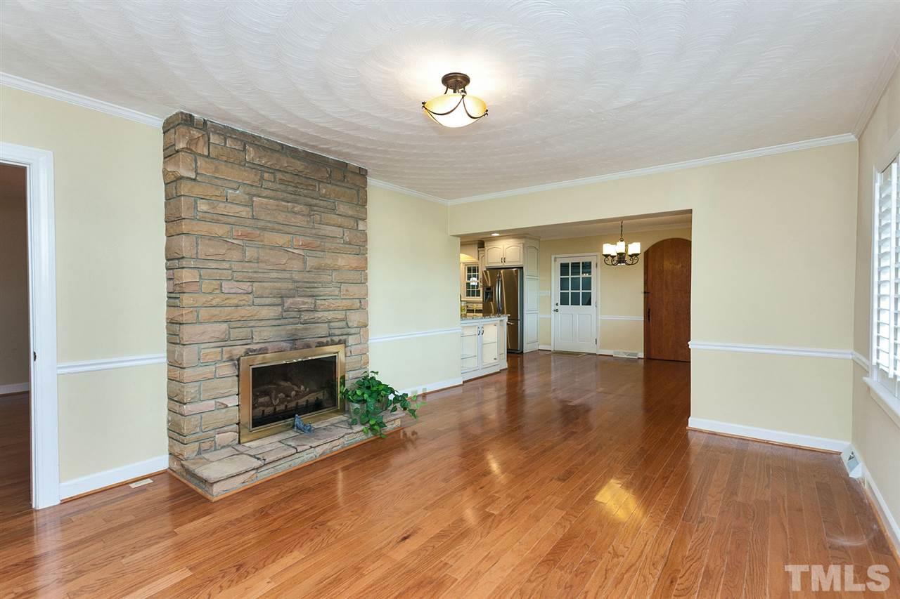90 Johnson Town Road Zebulon, NC 27597 - Photo 10 of 18 a view of an empty room with wooden floor and a fireplace