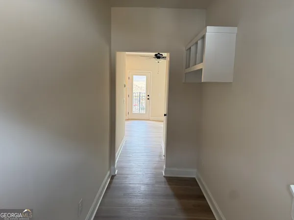 a view of a hallway with wooden floor
