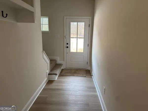 a view of a hallway with wooden floor