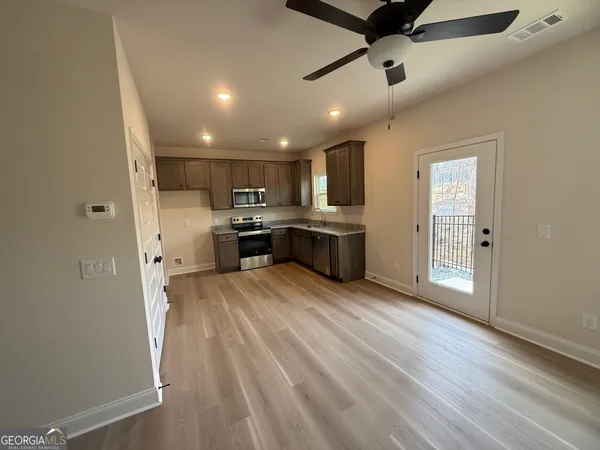 a view of kitchen with sink microwave and refrigerator