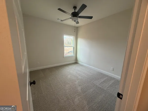 a view of a livingroom with a window and a ceiling fan