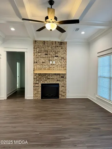 a view of a livingroom with a ceiling fan and a fireplace