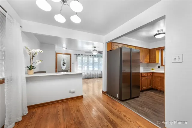 a kitchen with stainless steel appliances granite countertop a refrigerator and a sink