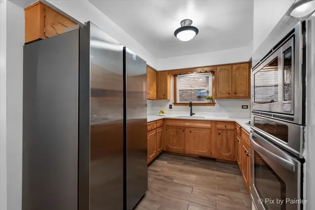 a kitchen with stainless steel appliances granite countertop a refrigerator a sink and dishwasher