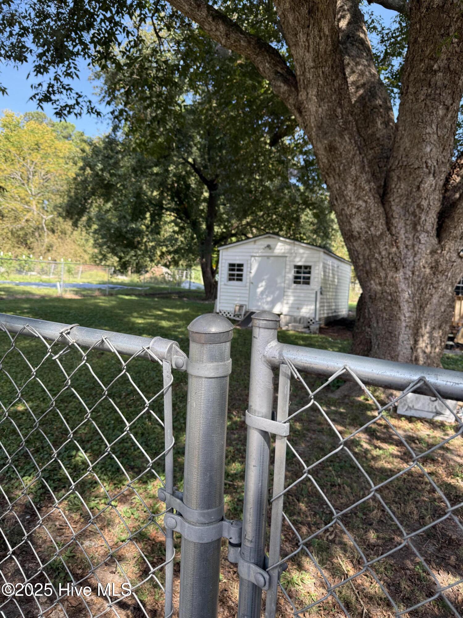 865 Pine Ridge Road Zebulon, NC 27597 - Photo 25 of 25 Wonderful fenced backyard and the white shed stays!